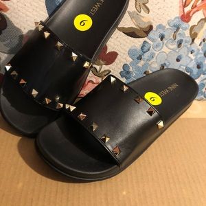 Nine West black studded (gold-tone) slides.
